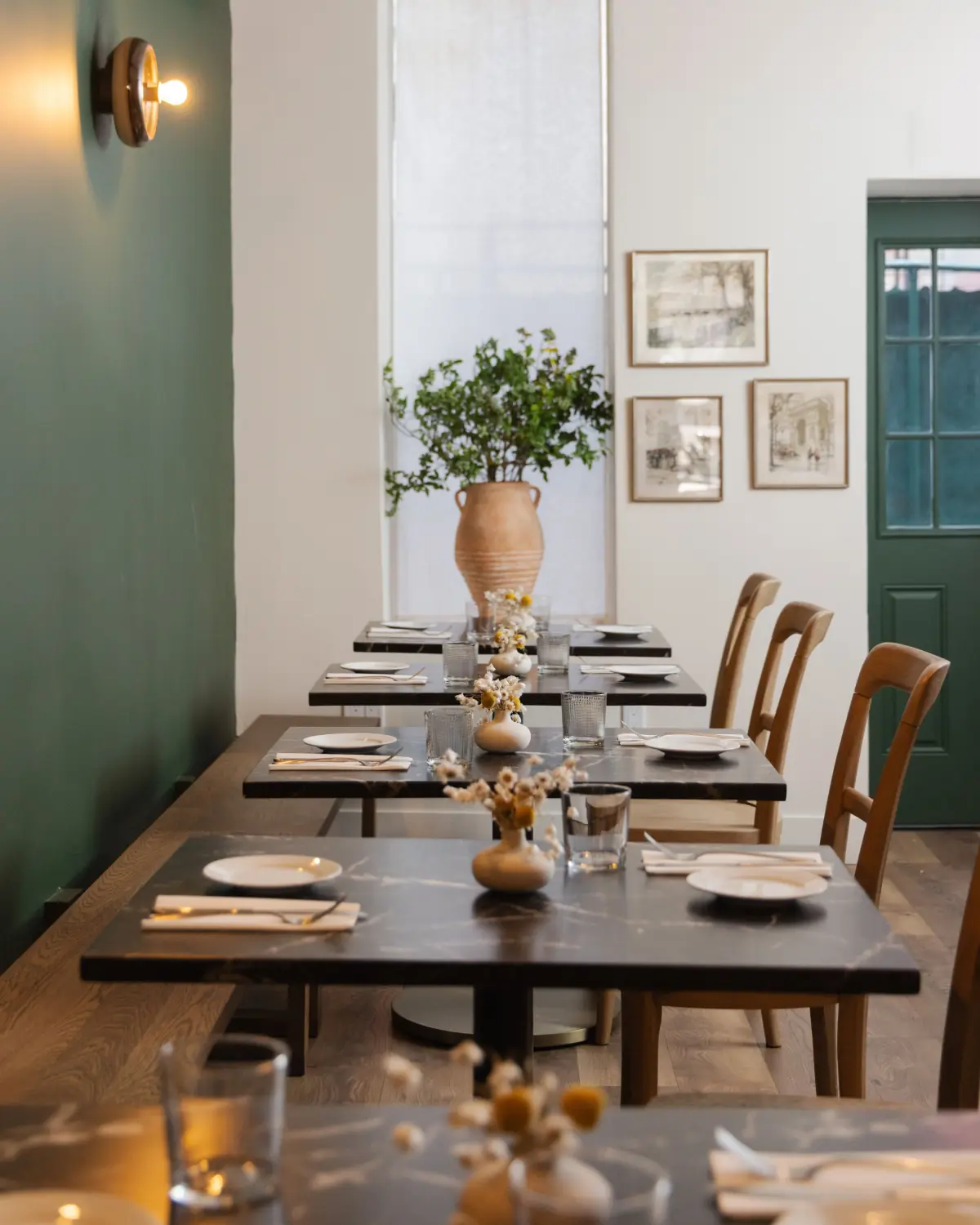 Set tables beside a green wall