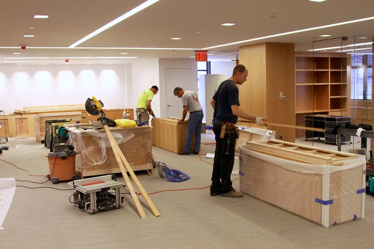 Carpenters building the reception desk on site
