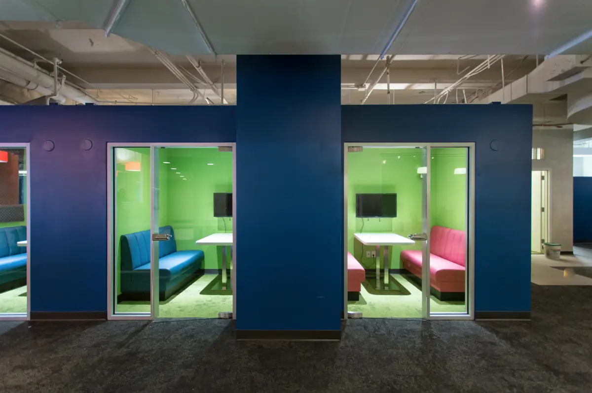 Glass phone rooms set into a navy wall